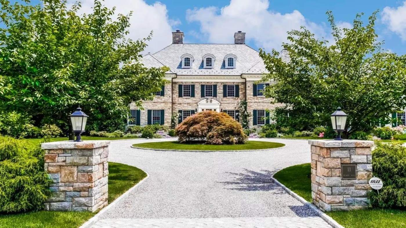 A stone Georgian behind gate piers, Westchester