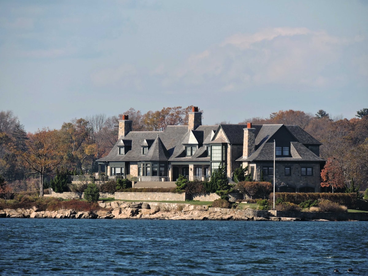 A stone and shingle house at the water’s edge — the Sound